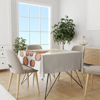 White tablecloth with candle-flame print on dining table in bright room