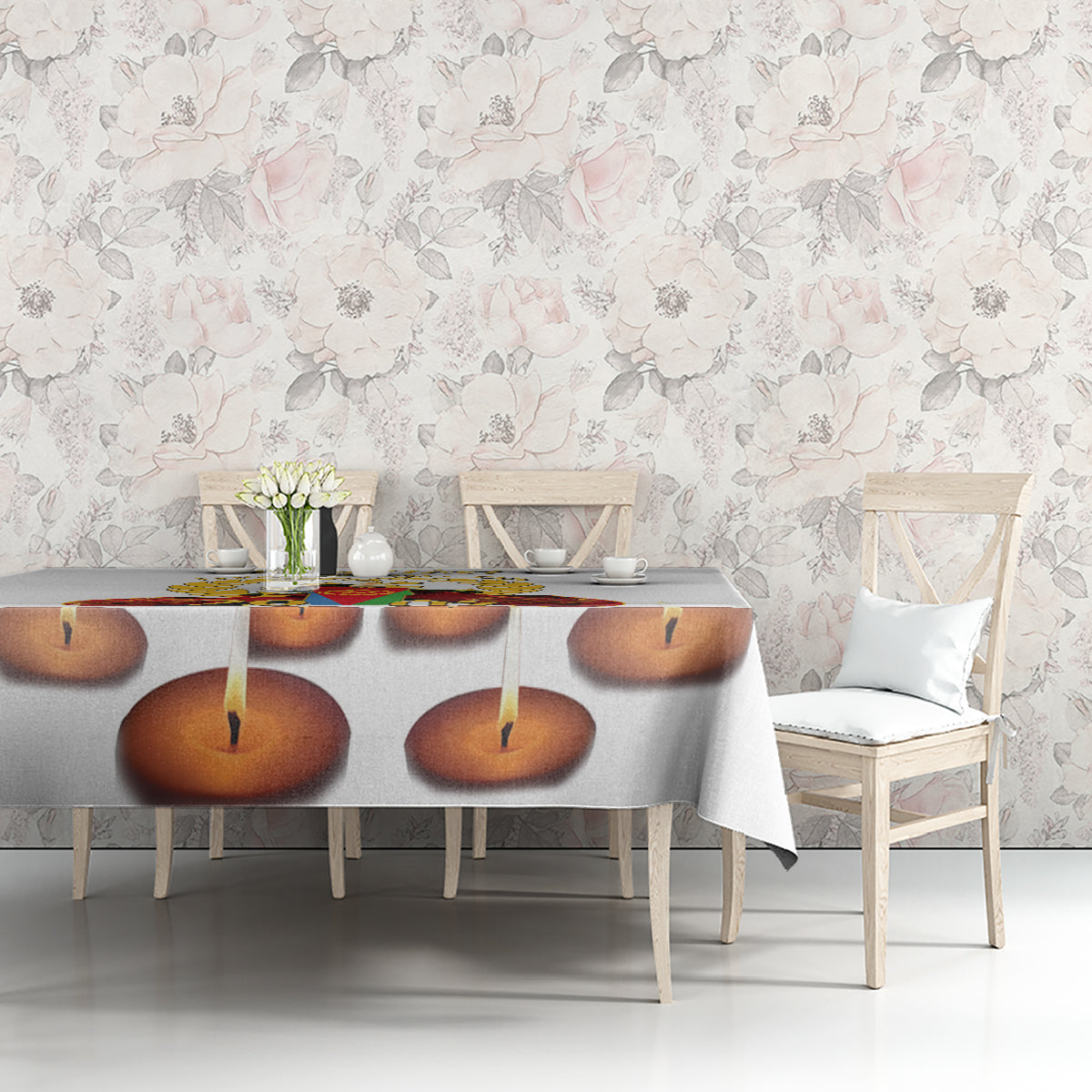 White tablecloth with candle-flame print on dining table against floral wall