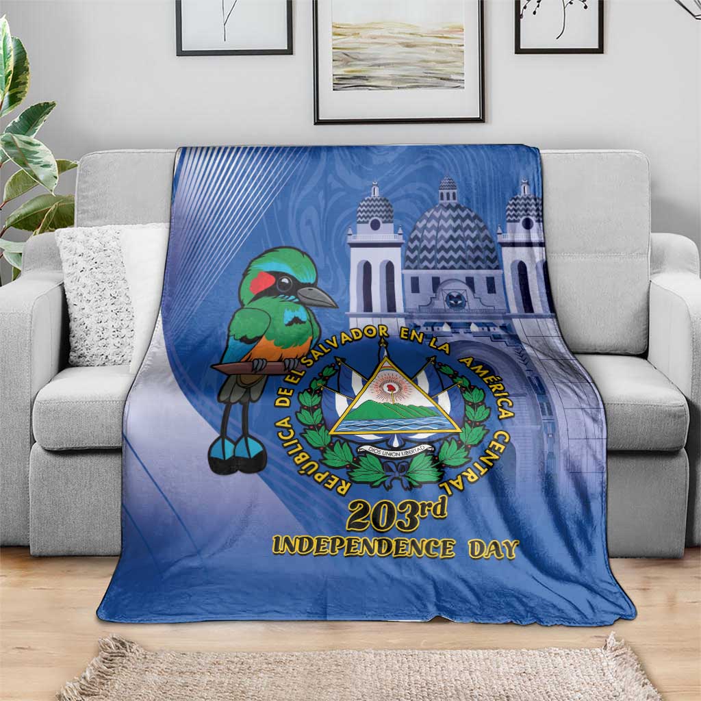 Blue Independence Day blanket draped on sofa with bird, crest, and “203rd Independence Day”