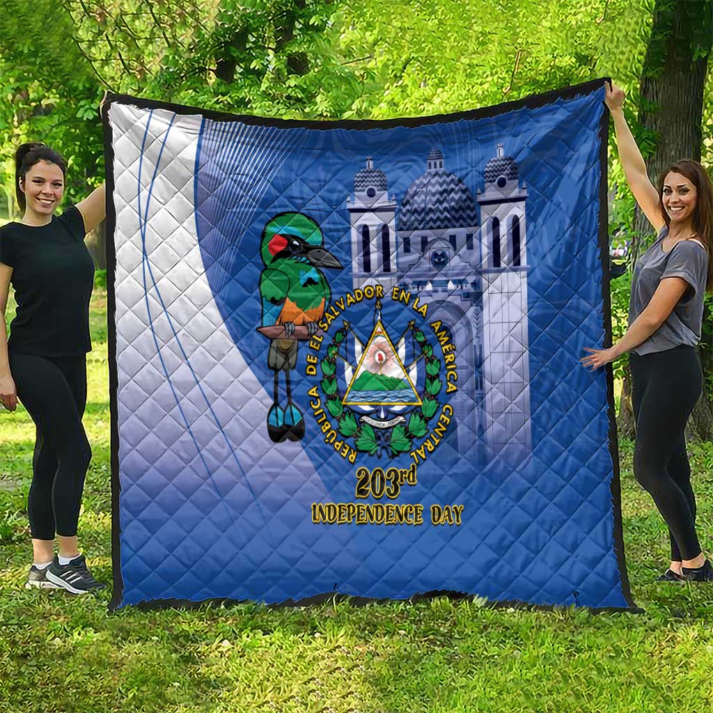 Blue quilt spread on grass with white side panel, bird crest emblem, and 203rd Independence Day text