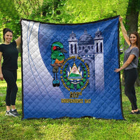 Blue quilt spread on grass with white side panel, bird crest emblem, and 203rd Independence Day text