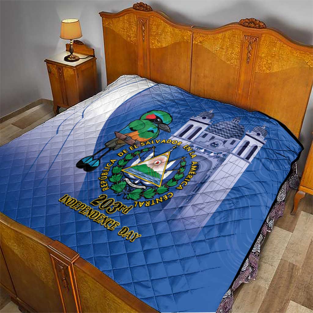 Blue quilt on bed with white diagonal paneling, central emblem, and “Independence Day” lettering
