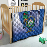 Blue quilt on crib with white diagonal panel, bird crest emblem, and “203rd Independence Day”