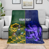 Rugby blanket on sofa: green and blue split with crest, lion, "YOUR TEXT"