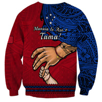 Red crewneck sweatshirt with blue pattern, 'Manuia le Aso o Tama' text and hand graphic