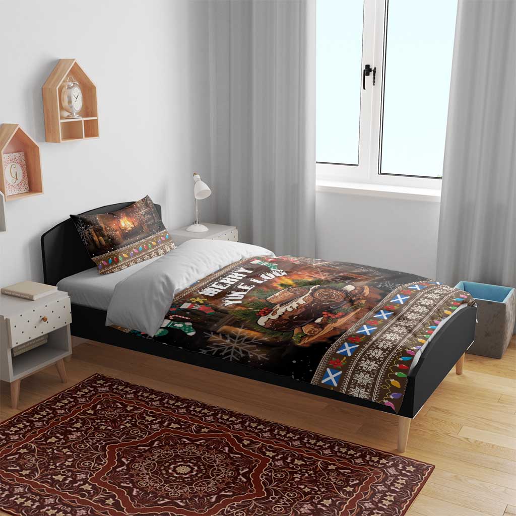 Christmas bedding set on bed with black “Merry Yule Log” print, fireplace scene, and patterned edge