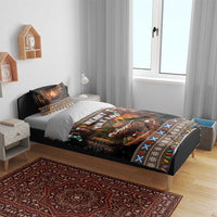 Christmas bedding set on bed with black “Merry Yule Log” print, fireplace scene, and patterned edge