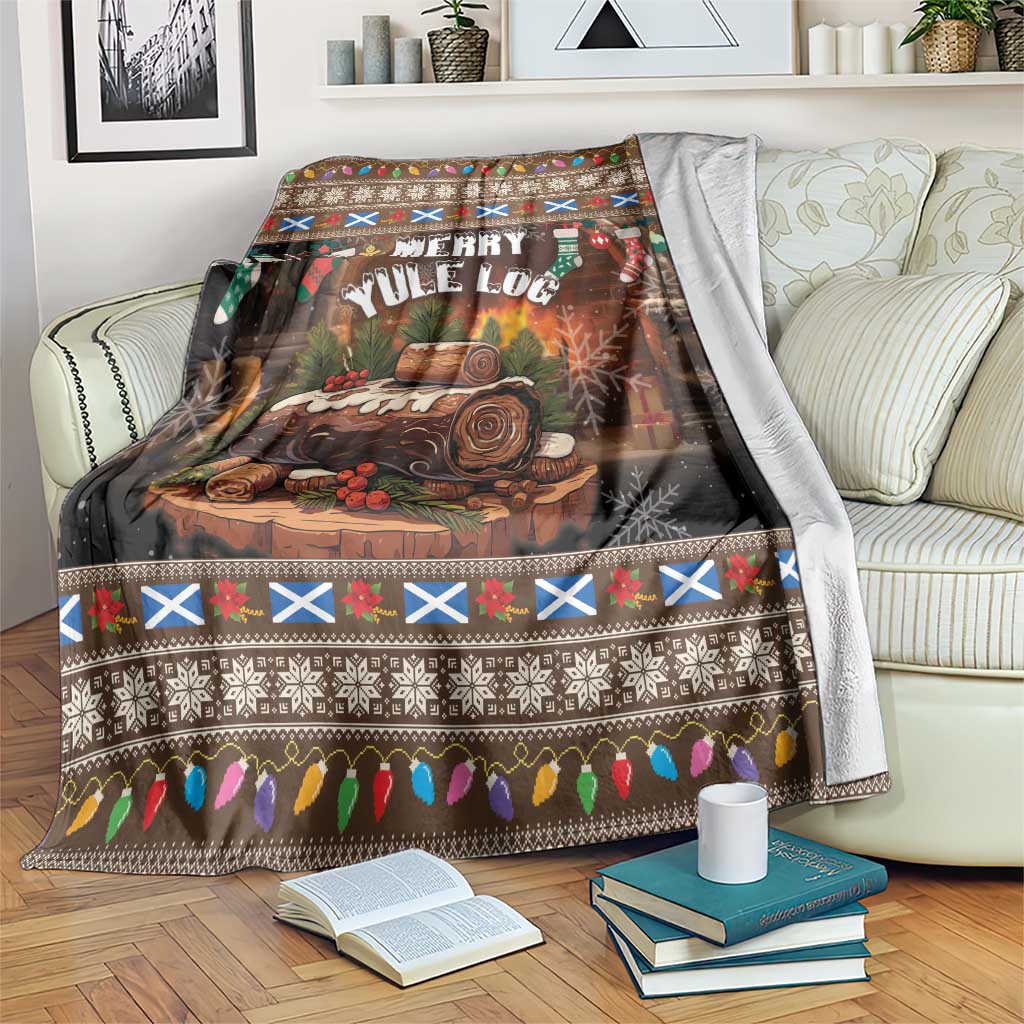 Christmas blanket with dark brown log scene and colorful holiday border, draped on a couch