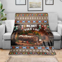 Merry Yule Log Christmas blanket with dark brown forest scene and festive trim, on a sofa