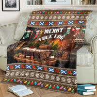 Christmas blanket with “Merry Yule Log” graphic, colorful stripes, and festive border on sofa