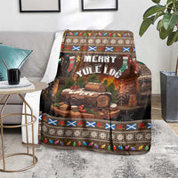 Dark brown Christmas throw blanket with log artwork and multicolor holiday trim on living room floor