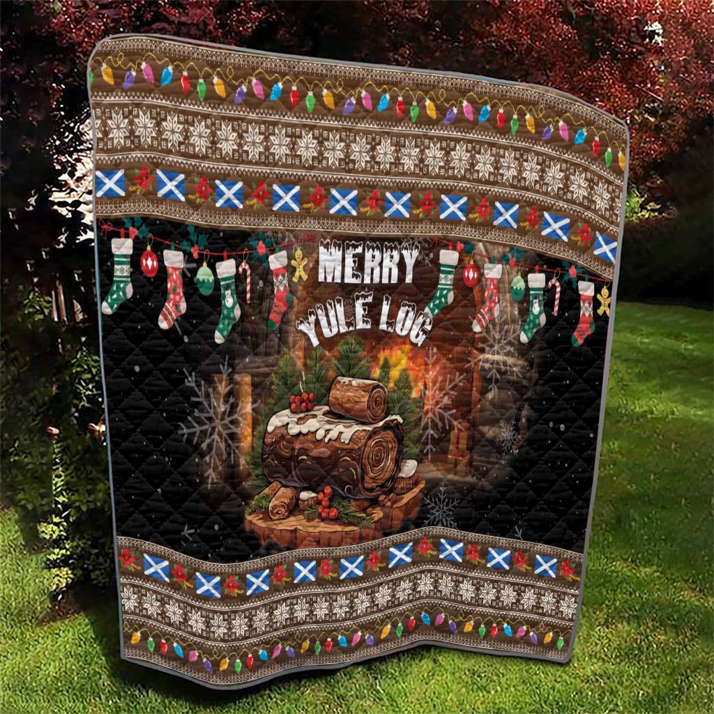 Dark quilt with Merry Yule Log text, log fire artwork, stockings, and patterned top border.