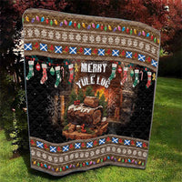 Dark quilt with Merry Yule Log text, log fire artwork, stockings, and patterned top border.