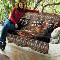 Dark quilt with Merry Yule Log design, stockings and flame log center, on outdoor seating.