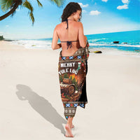 Brown Christmas sarong with 'Merry Yule Log' centered print and patterned hem