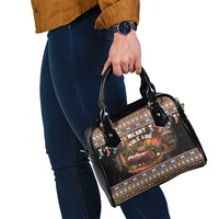 Black festive print shoulder handbag with adjustable strap and gold-tone hardware