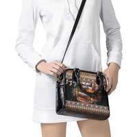 Black festive print shoulder handbag with long crossbody strap and zip closure