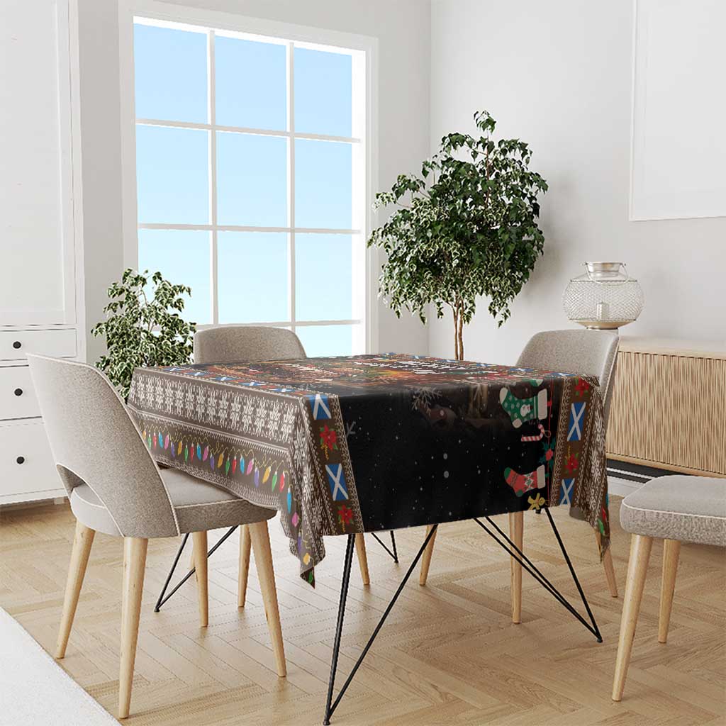 Christmas tablecloth on dining table, dark base with colorful patterned trim and holiday icons.