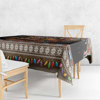 Rectangle Christmas tablecloth draped over table edge, dark base with festive border and icons.
