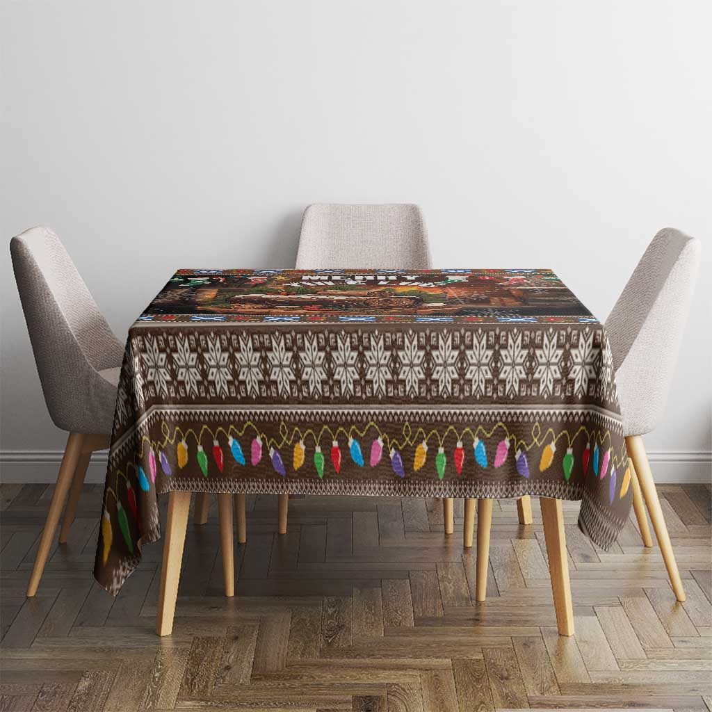 Dark Christmas tablecloth with snowflake band and multicolor ornament fringe around the edges.