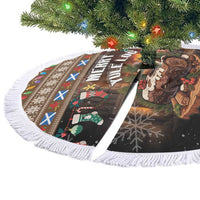 Round Christmas tree skirt with “Merry Yule Log” artwork and white tassel fringe border