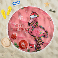 Pink round Christmas beach blanket with flamingo graphic and fringed edge