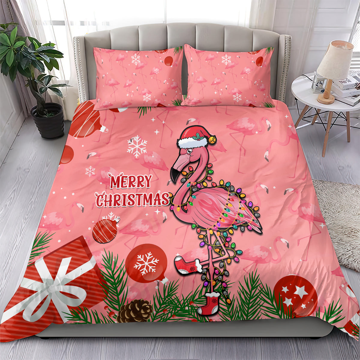 Pink bedding set on bed with two matching pillowcases, cartoon flamingo and “Merry Christmas”.
