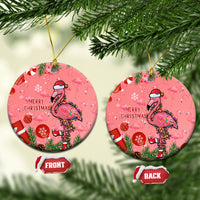 Pink round ceramic Christmas ornament with flamingo, wreath, and “Merry Christmas” text
