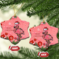 Two pink bell-shaped ceramic Christmas ornaments with flamingo and “Merry Christmas”