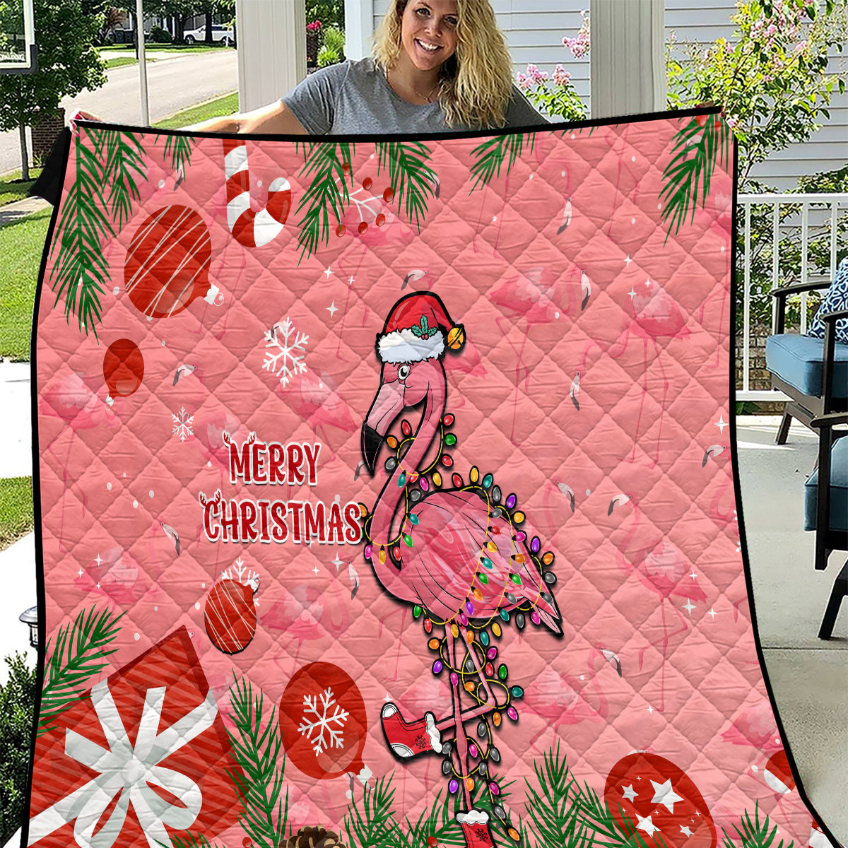 Pink Christmas quilt with flamingo, pine branches, and “Merry Christmas” text