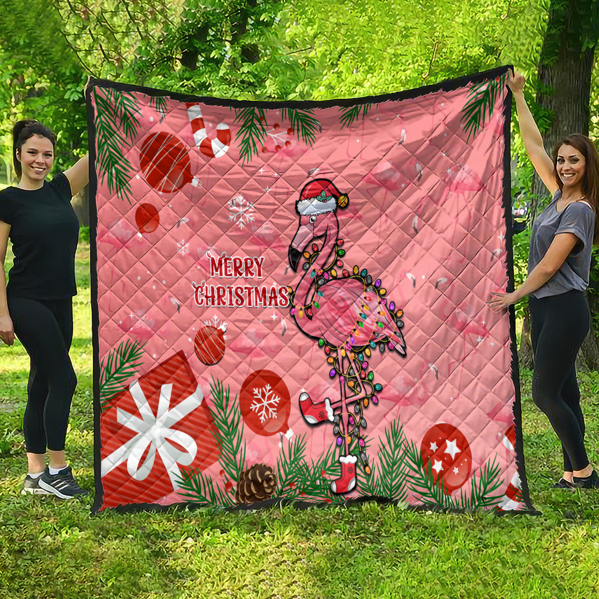 Pink flamingo holiday quilt with quilted diamond stitching, ornaments, and “Merry Christmas”