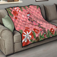 Pink Christmas quilt throw on living room couch with flamingo, snowflake accents