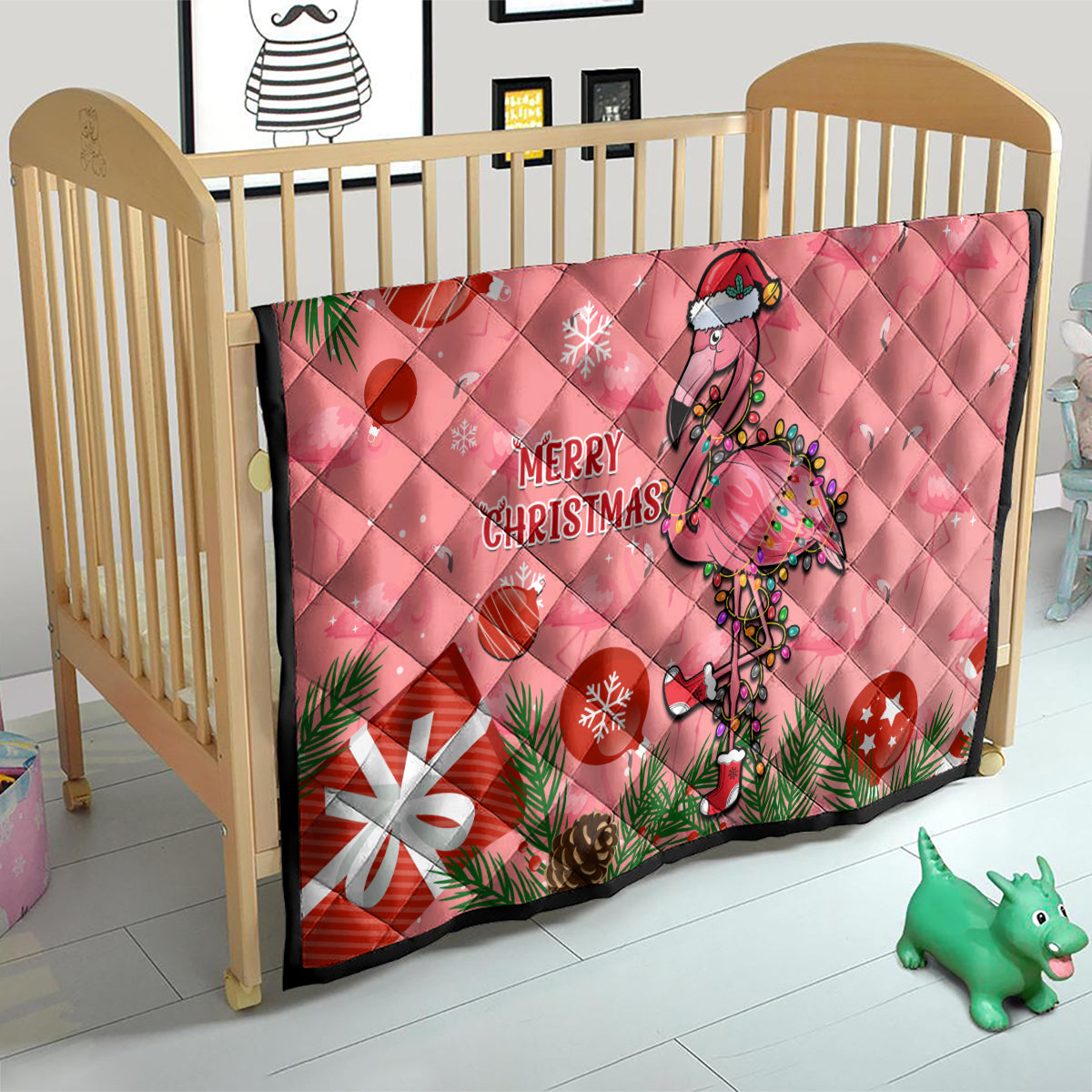 Pink flamingo Christmas quilt on baby bed, quilted diamonds with “Merry Christmas”