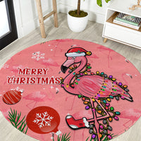 Pink round Christmas carpet with “MERRY CHRISTMAS” text and flamingo graphic