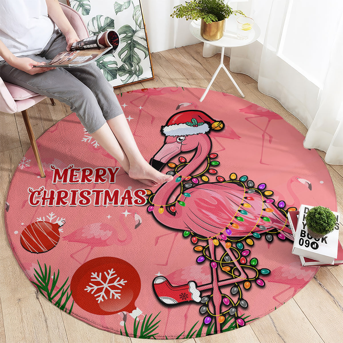 Pink round Christmas carpet with “MERRY CHRISTMAS” and decorated flamingo illustration