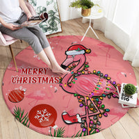 Pink round Christmas carpet with “MERRY CHRISTMAS” and decorated flamingo illustration