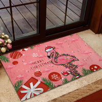 Pink flamingo Christmas rubber doormat with 'Merry Christmas' and candy-cane decorations