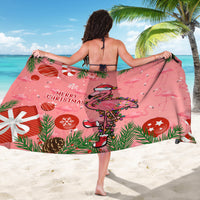 Pink Christmas sarong with flamingo and ornaments print, worn showing back view