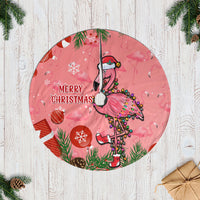 Pink flamingo Christmas tree skirt with seamless round design and holiday icons