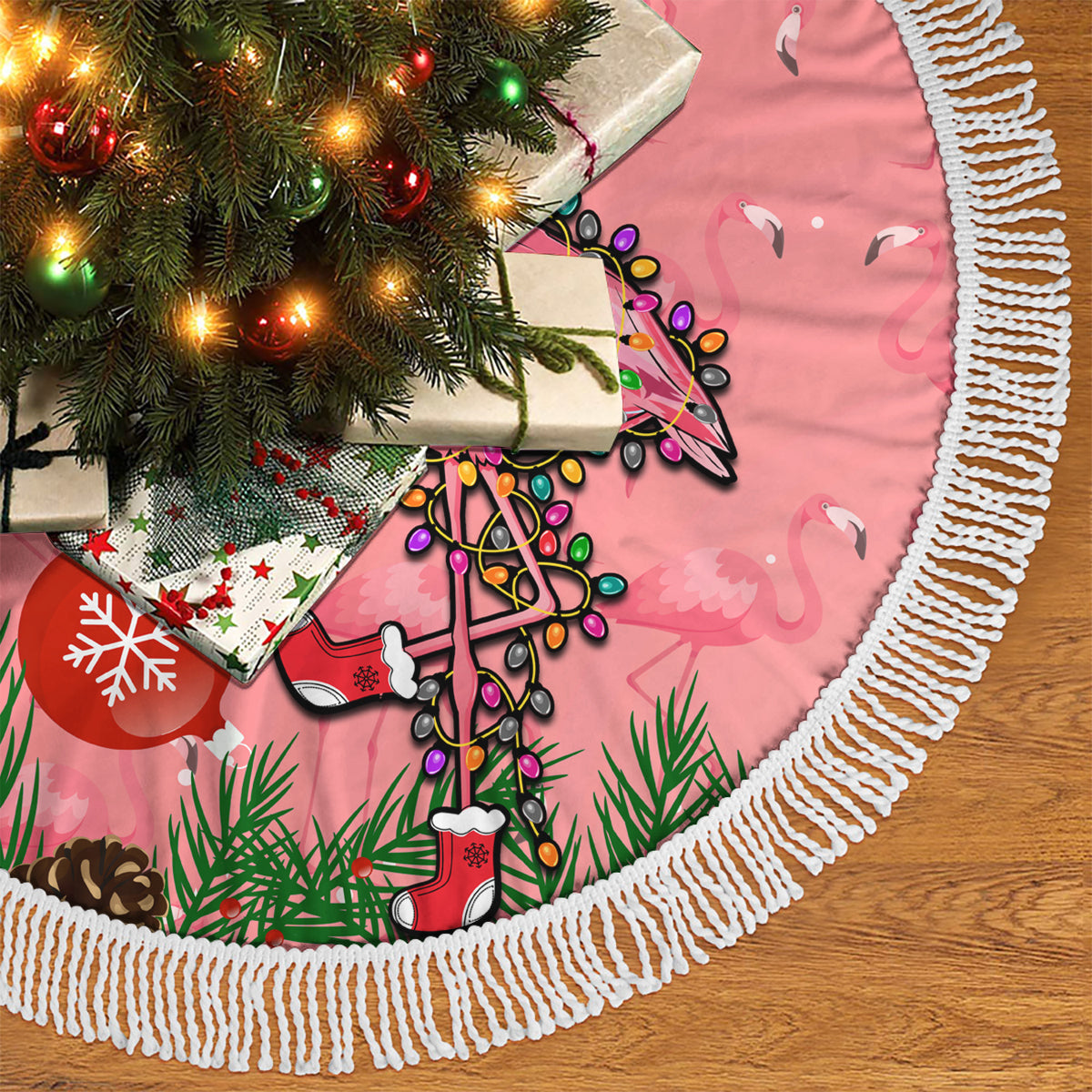 Pink flamingo Christmas tree skirt with white fringed trim and illustrated holiday motifs