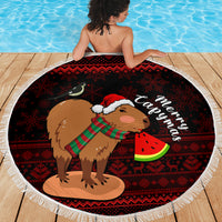 Round Christmas beach blanket featuring capybara with Santa hat holding watermelon, fringe border