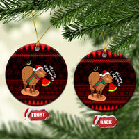 Round ceramic Christmas ornament with capybara Santa holding a watermelon, red pattern