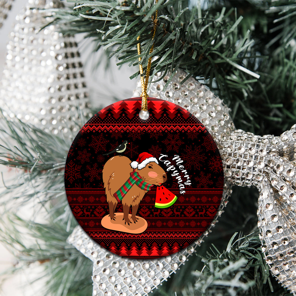 Round ceramic Christmas ornament featuring capybara in Santa hat holding watermelon slice