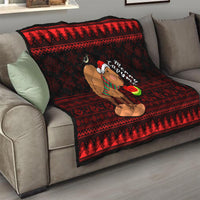 Red and black Christmas capybara quilt draped on a sofa, featuring Santa-hat capybara