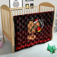 Red and black Christmas capybara quilt on a baby bed frame, with Santa-hat capybara graphic