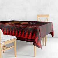 Red Christmas tablecloth with dark pine-tree pattern and striped border, corner hanging