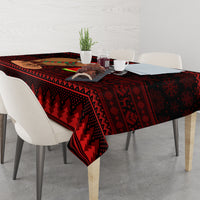 Red Christmas tablecloth with dark triangular pattern, draped on dining table