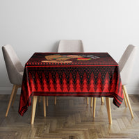 Red and dark geometric Christmas tablecloth, square drape over table with chairs