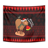 Red and black tapestry close view: capybara in Santa hat holding watermelon slice