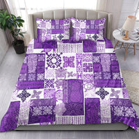 Purple patchwork quilt bedding set with white floral and geometric tile patterns, flat sheet